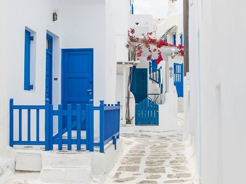 A cobalt-blue gate set into a whitewashed wall in the Chora