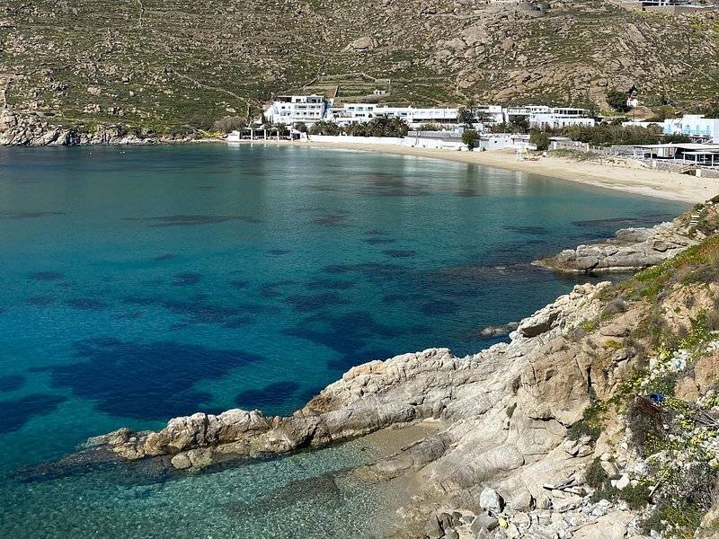 A quiet rocky cove with water clear enough to see the bottom