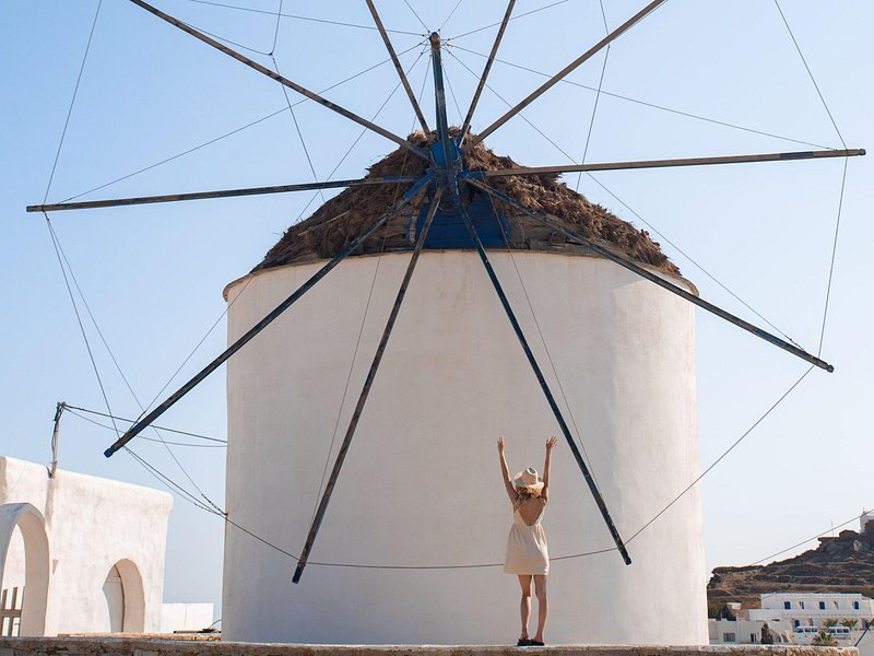 A thatched Mykonos windmill cap and its four sail spars from below