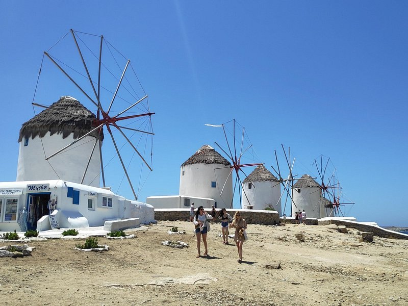 Whitewashed windmills standing in a row above the Chora